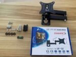 TV wall mount installation kit with screws and packaging on wooden table