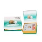 AXON K-86 hearing aid retail packaging box closed and open, displaying the amplifier device, ear tips, and accessories.