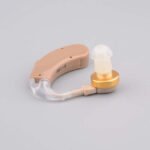 Side view of Axon Model X-168 hearing aid with serial number 89-X-168 on light brown body.