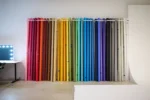 Full Range of Photography Backdrop Paper Rolls on Wall Mount Display