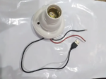 White bulb holder hidden camera with USB cable and wiring connections detail.