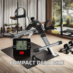 An indoor gym scene featuring a "COMPACT DESK BIKE" with a timer, dumbbells, and fitness racks near a large window with plants.